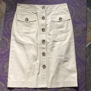 Button front of khaki skirt w/ front flap pockets